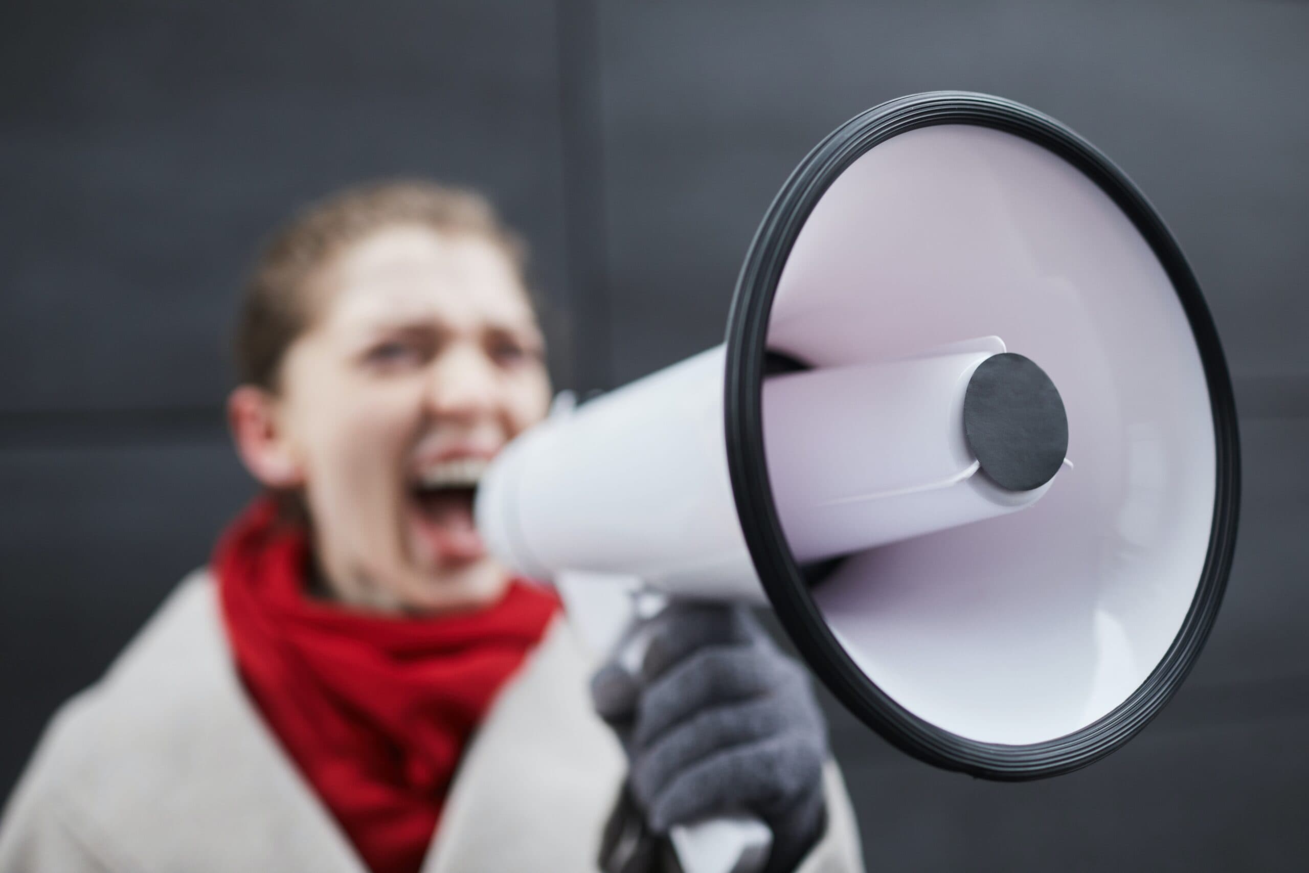 Woman speaking into a loudspeaker