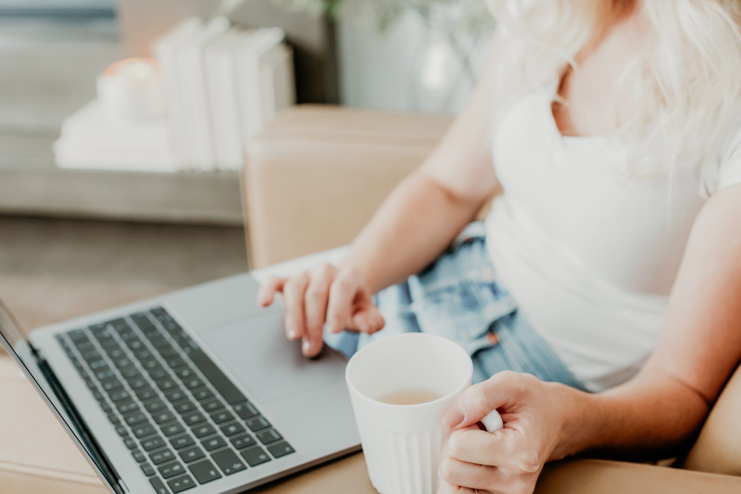 Woman typing on a laptop.